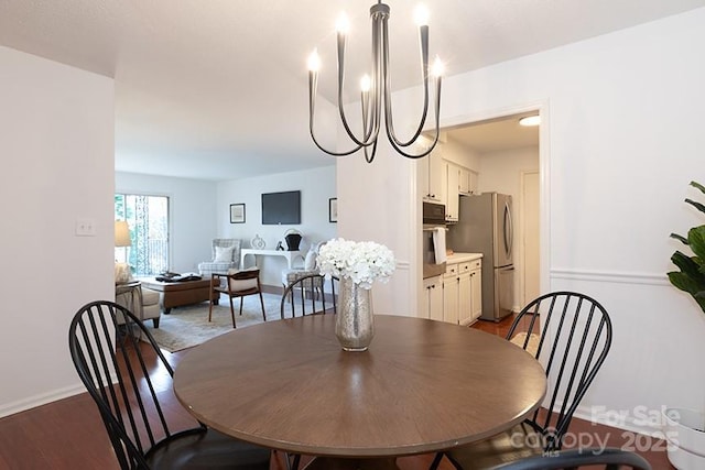 dining space featuring a notable chandelier and hardwood / wood-style flooring