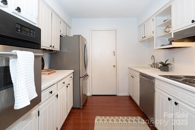 kitchen with white cabinets, appliances with stainless steel finishes, sink, and dark hardwood / wood-style floors