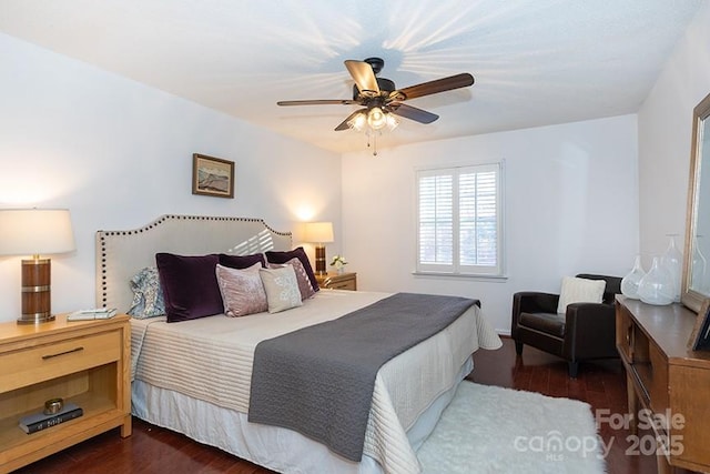 bedroom featuring ceiling fan and dark wood-type flooring