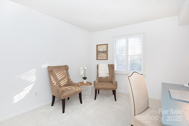 sitting room featuring light colored carpet