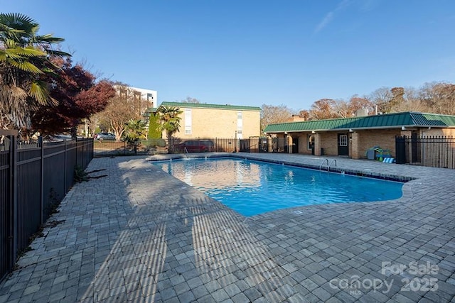 view of pool with pool water feature and a patio