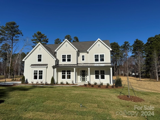 view of front of house featuring a front yard and a porch