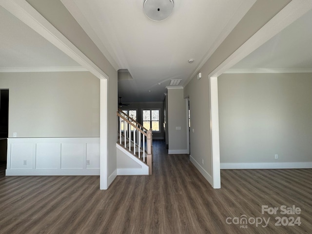 interior space featuring dark wood-type flooring, ceiling fan, and ornamental molding