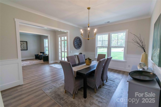 1875 Rock Hill Church Rd Unit 4, Matthews, NC 28104 - dining room featuring a chandelier, wood finished floors, plenty of natural light, a wainscoted wall, and crown molding