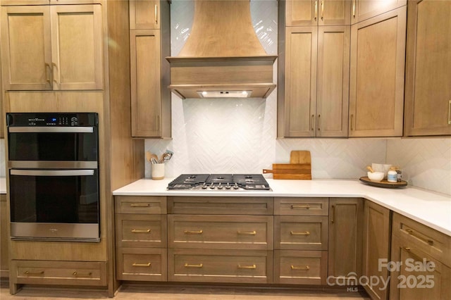 1875 Rock Hill Church Rd Unit 4, Matthews, NC 28104 - kitchen featuring custom range hood, stainless steel gas stovetop, tasteful backsplash, and light countertops