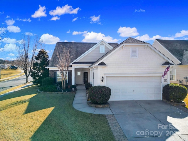 view of front facade with a front yard and a garage