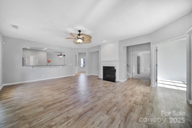 unfurnished living room featuring light hardwood / wood-style floors and ceiling fan