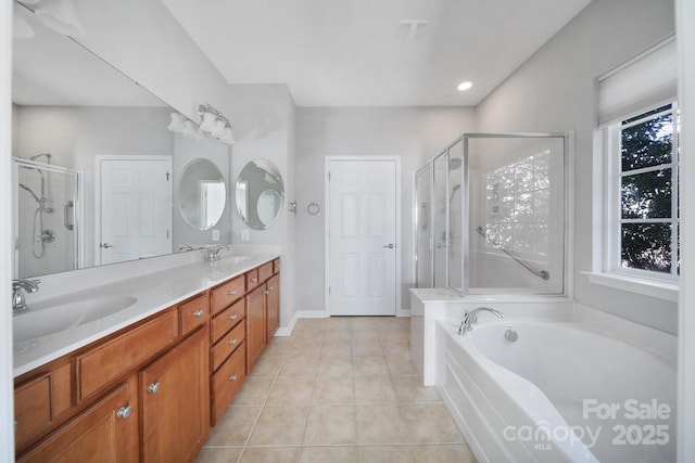 bathroom featuring tile patterned flooring, vanity, and shower with separate bathtub