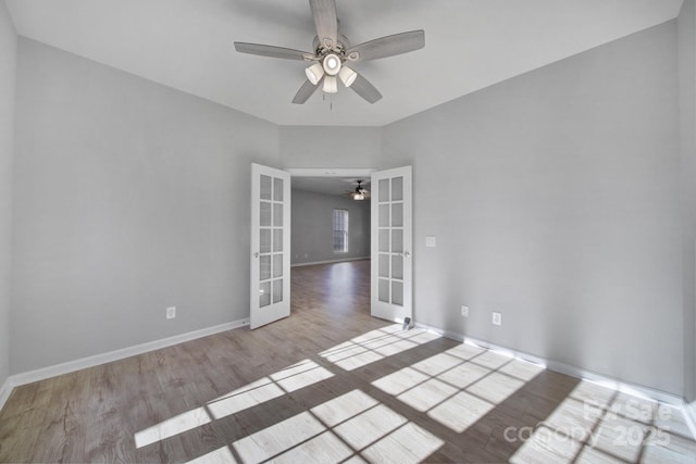 spare room with french doors, light wood-type flooring, and ceiling fan