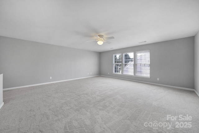 empty room with ceiling fan and light colored carpet