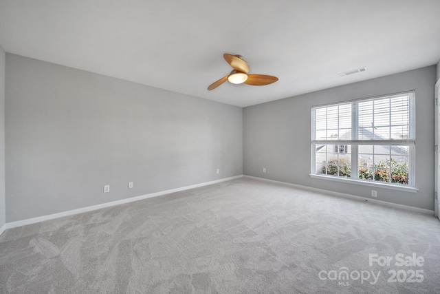 spare room with light colored carpet and ceiling fan