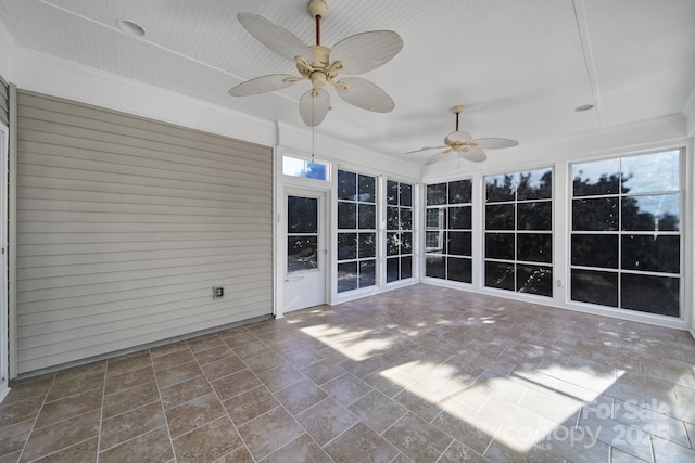 unfurnished sunroom with ceiling fan