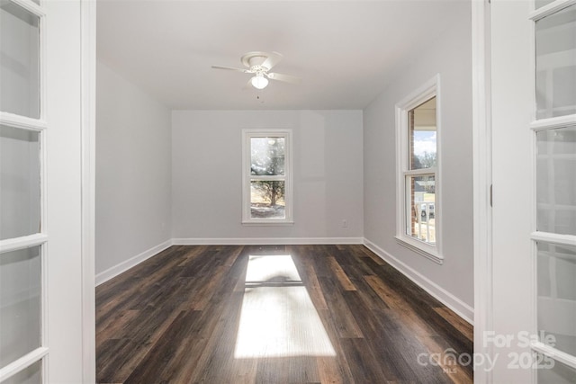 spare room featuring ceiling fan, dark hardwood / wood-style flooring, and a healthy amount of sunlight