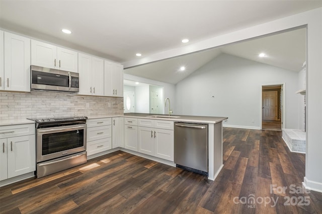 kitchen featuring kitchen peninsula, white cabinets, and stainless steel appliances