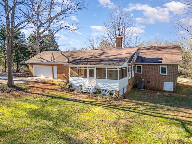 single story home featuring central AC unit, a front yard, a garage, and a sunroom