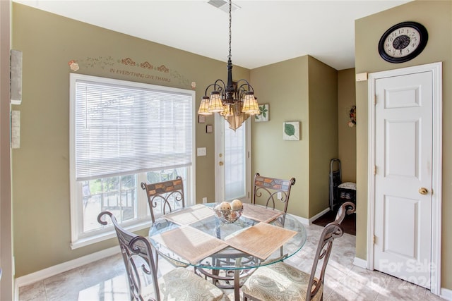 dining space with a chandelier