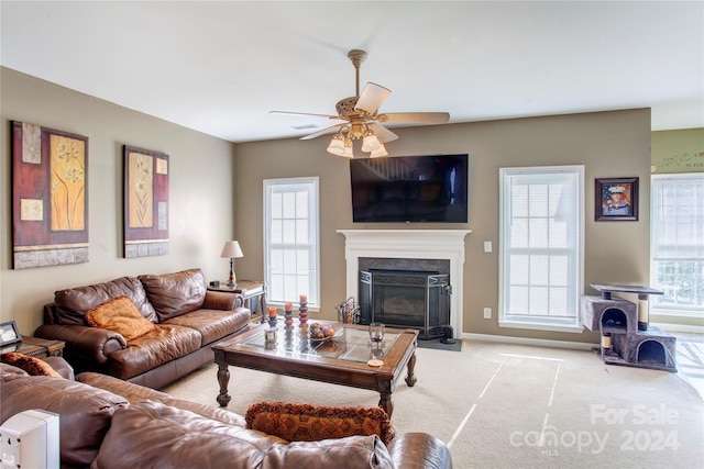 living room featuring ceiling fan, a healthy amount of sunlight, and light carpet