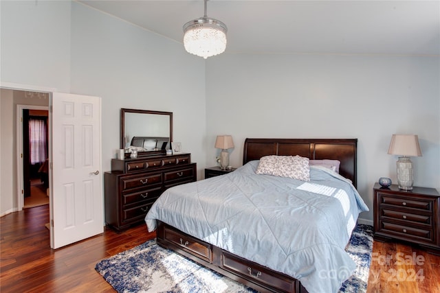 bedroom featuring dark hardwood / wood-style floors and vaulted ceiling