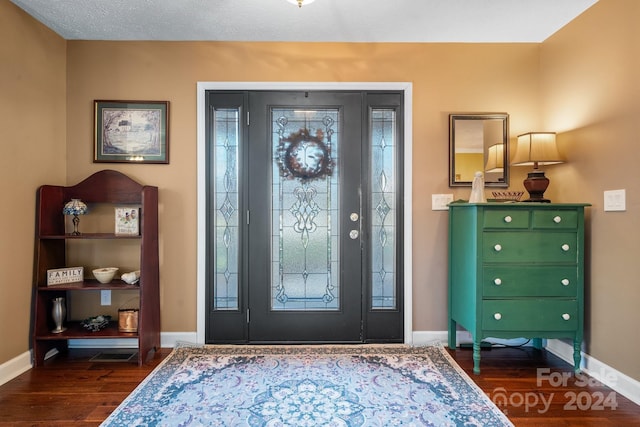 entryway with dark hardwood / wood-style floors and a wealth of natural light