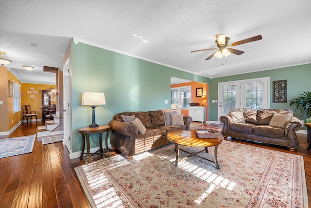 living room with a textured ceiling, crown molding, ceiling fan with notable chandelier, and dark hardwood / wood-style floors