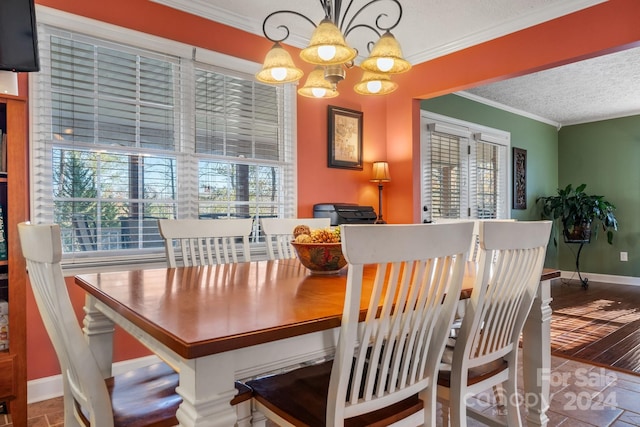 dining room featuring crown molding, plenty of natural light, wood-type flooring, and a textured ceiling