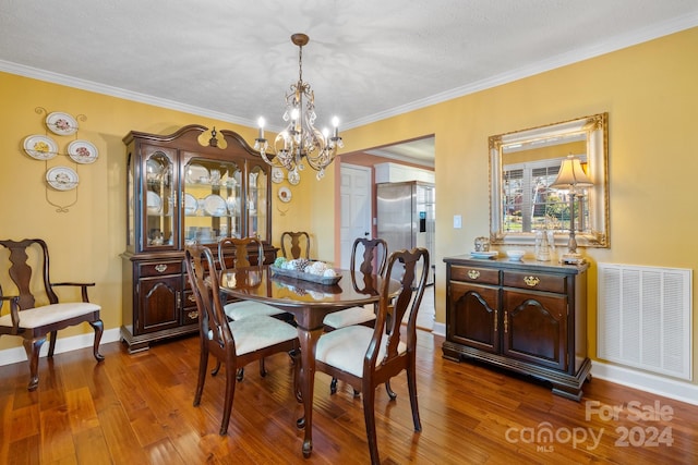 dining space featuring dark hardwood / wood-style flooring, a textured ceiling, and ornamental molding