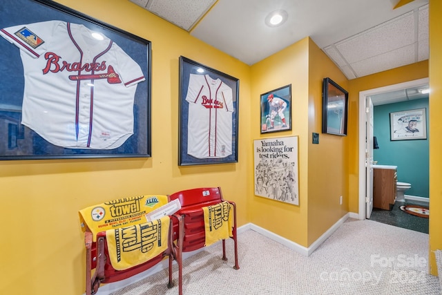 game room with carpet flooring and a drop ceiling