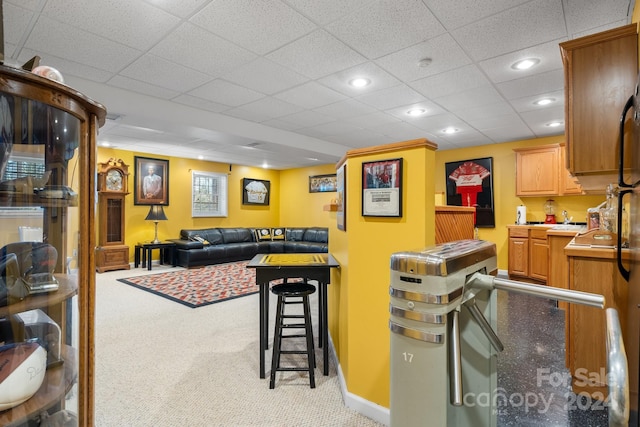 kitchen featuring a breakfast bar area and light carpet