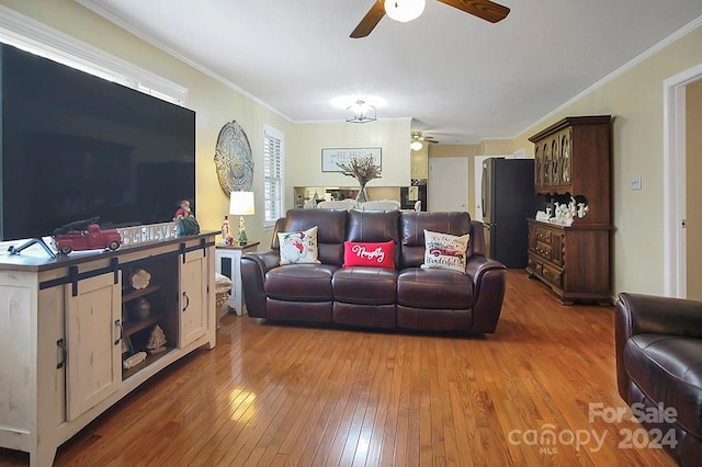 living room featuring hardwood / wood-style floors, ceiling fan, and ornamental molding