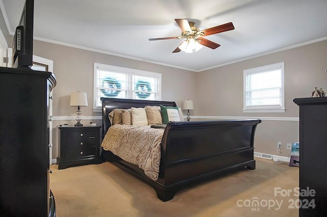 bedroom featuring carpet flooring, ceiling fan, ornamental molding, and multiple windows