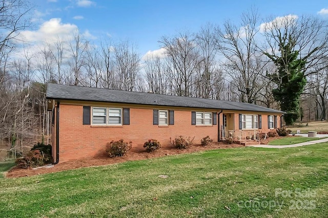 ranch-style home with a front yard and brick siding