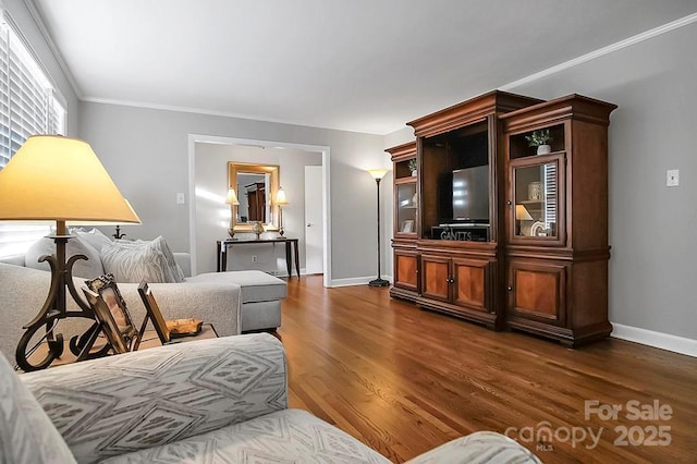 living room with crown molding, baseboards, and dark wood-style flooring