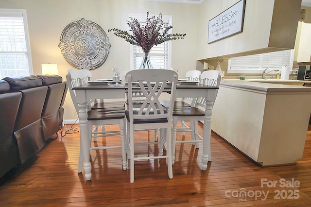 dining space with hardwood / wood-style floors