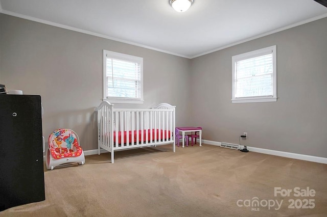 bedroom with ornamental molding, multiple windows, and baseboards