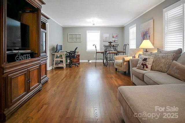 living room with ornamental molding, dark wood-type flooring, and baseboards