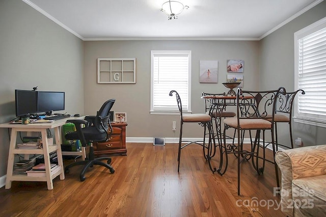 office area featuring crown molding, baseboards, and wood finished floors