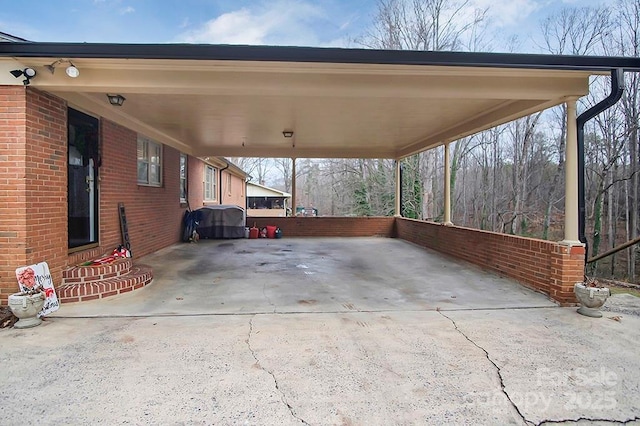 view of patio / terrace with an attached carport and driveway