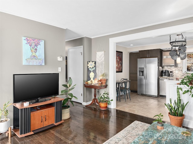 living room with light wood-type flooring and ornamental molding