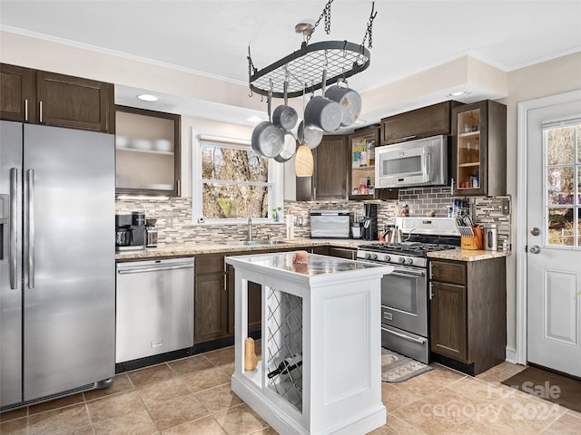 kitchen with decorative backsplash, a healthy amount of sunlight, and appliances with stainless steel finishes