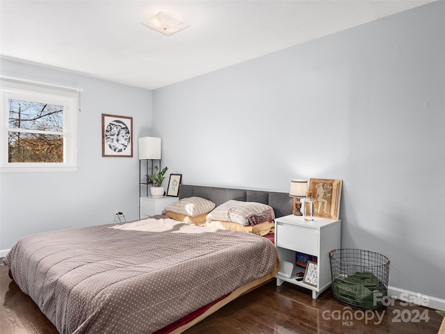 bedroom featuring dark hardwood / wood-style flooring