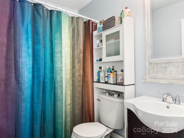 bathroom featuring vanity, toilet, and walk in shower