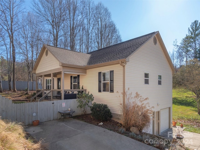 view of front of home with a porch and a garage