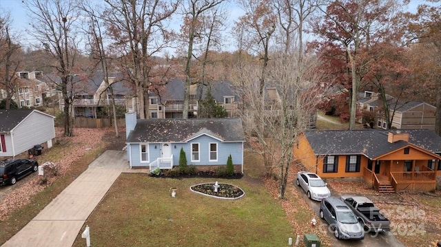 1928 Boulding Ave, High Point, NC 27265 - view of front of home with concrete driveway, a front yard, a residential view, a chimney, and a porch