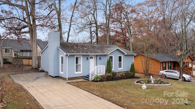 1928 Boulding Ave, High Point, NC 27265 - view of front of property with a chimney, concrete driveway, and a shingled roof