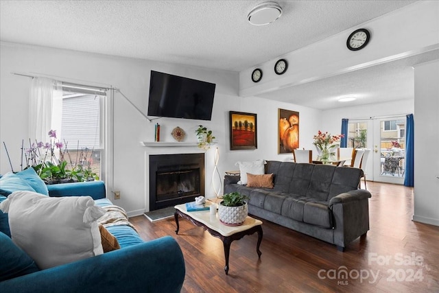 1928 Boulding Ave, High Point, NC 27265 - living area featuring wood finished floors, a textured ceiling, and a glass covered fireplace