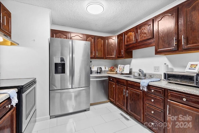 kitchen featuring appliances with stainless steel finishes, a textured ceiling, exhaust hood, sink, and light tile patterned flooring