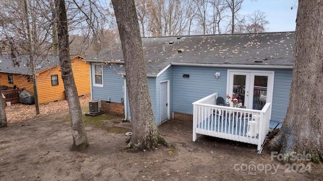 back of house with french doors, central air condition unit, and a wooden deck