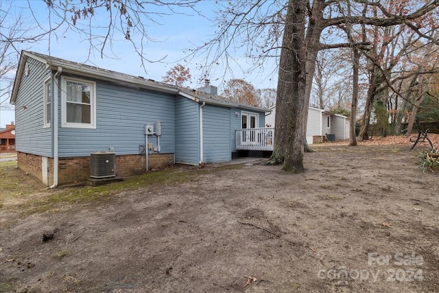 back of property featuring central AC unit and a deck