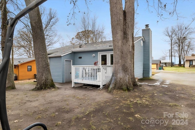 back of house featuring a deck and french doors