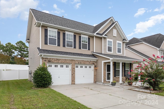 craftsman inspired home with a front yard and a garage